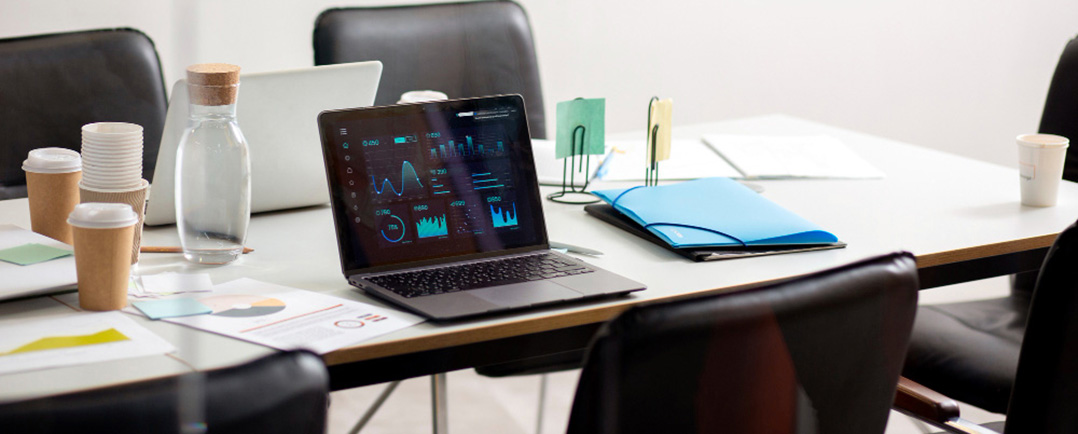 Laptop and papers on desk